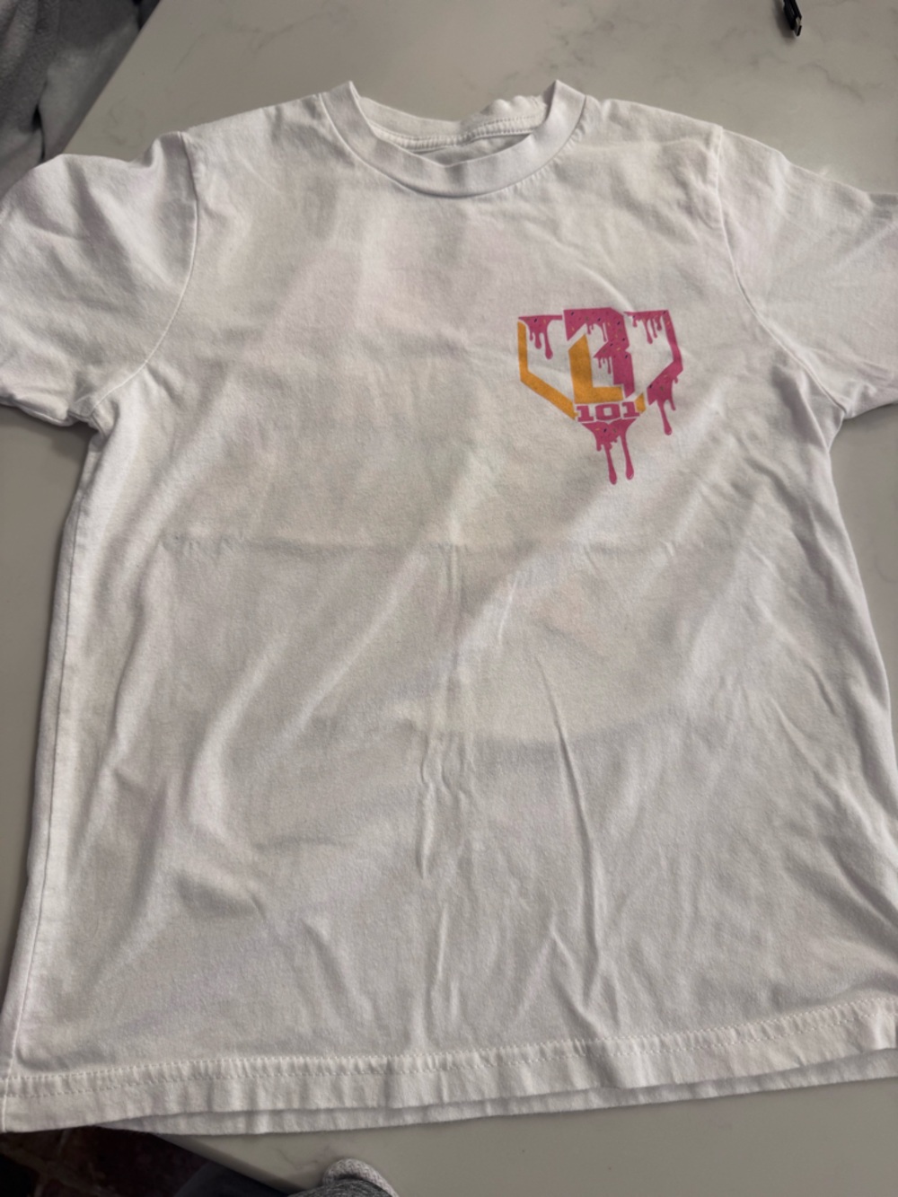 Baseball Lifestyle 101- Youth White Graphic Tee with Pink and Gold Drip Logo